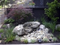 Fountain and plantings in corner of house